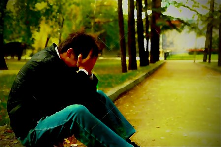 21827115-sad-young-man-sitting-in-the-autumn-park-with-hidden-face 2
